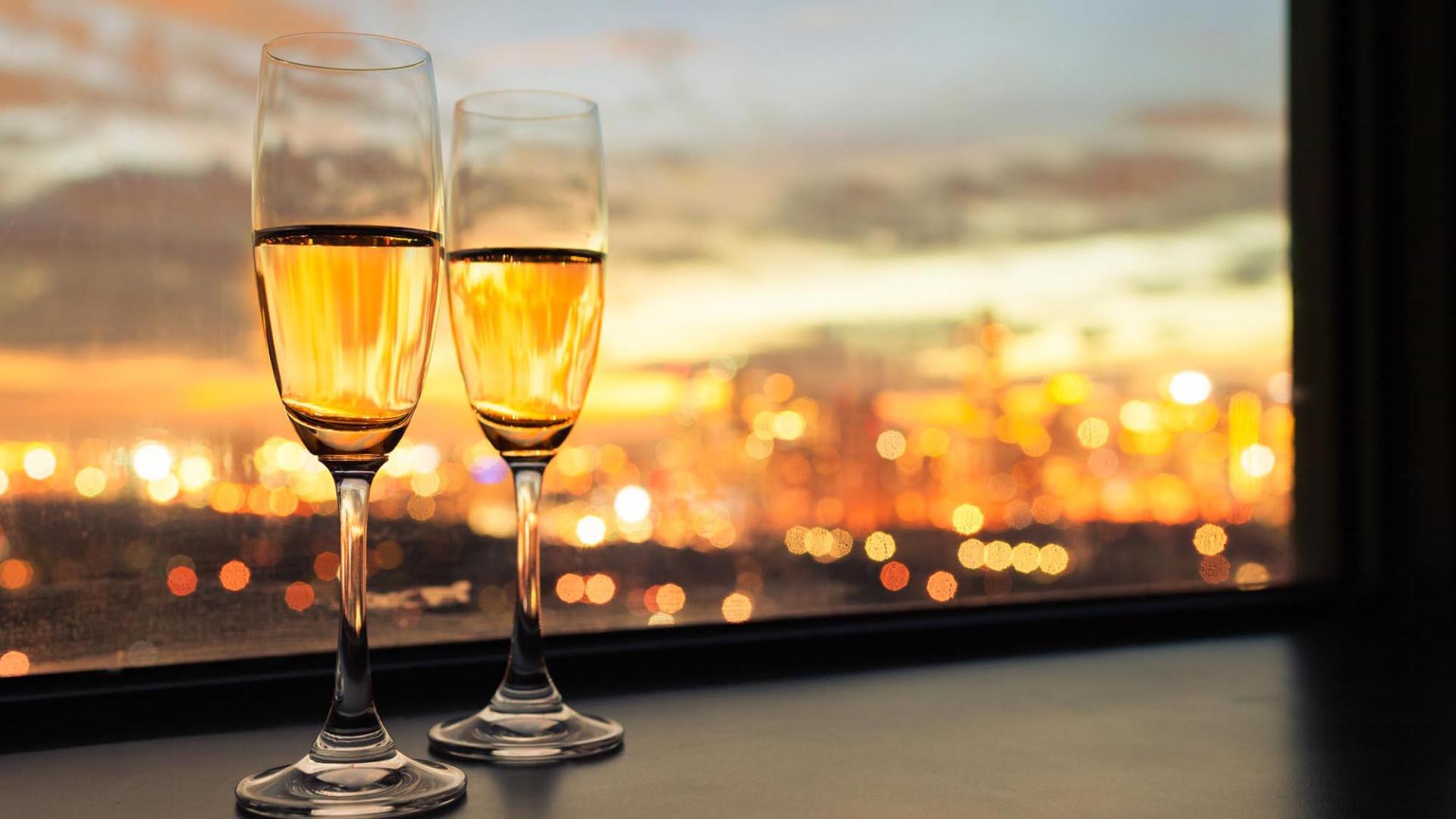 Two glasses of champagne with city view