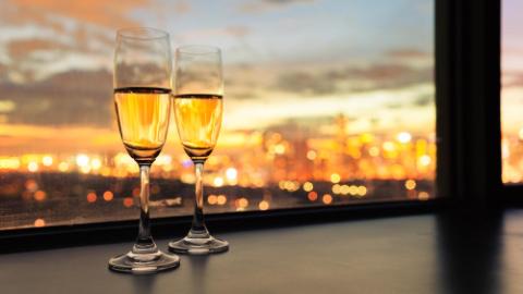 two champagne glasses and beautiful city views